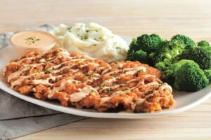 Juicy BLOOMIN' FRIED CHICKEN seasoned and cooked to golden perfection at Outback Steakhouse