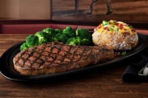 BONE-IN RIBEYE 18 OZ. grilled to perfection with Outback signature seasoning