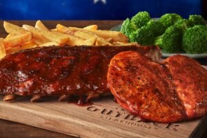 Juicy DROVER'S RIBS & CHICKEN PLATTER seasoned and cooked to golden perfection at Outback Steakhouse