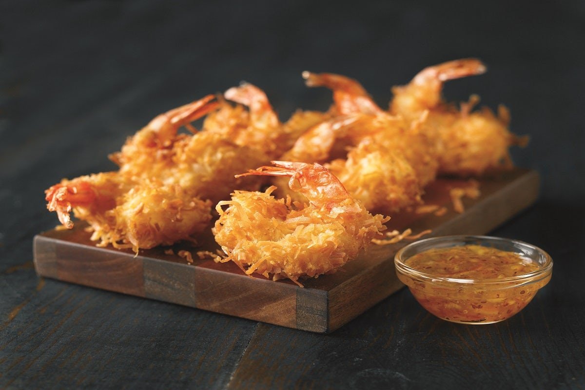 Fresh GOLD COAST COCONUT SHRIMP prepared with coastal flavors and served with our signature sauces