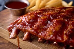 Fall-off-the-bone OUTBACK RIBS slow-cooked and glazed with tangy BBQ sauce