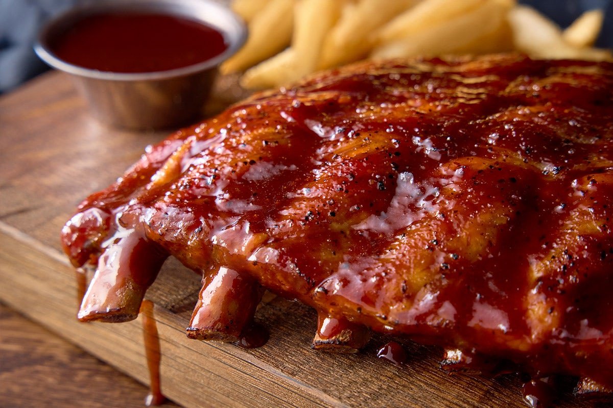 Fall-off-the-bone OUTBACK RIBS slow-cooked and glazed with tangy BBQ sauce