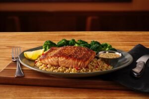 Outback Steakhouse PERFECTLY GRILLED SALMON beautifully plated and ready to enjoy