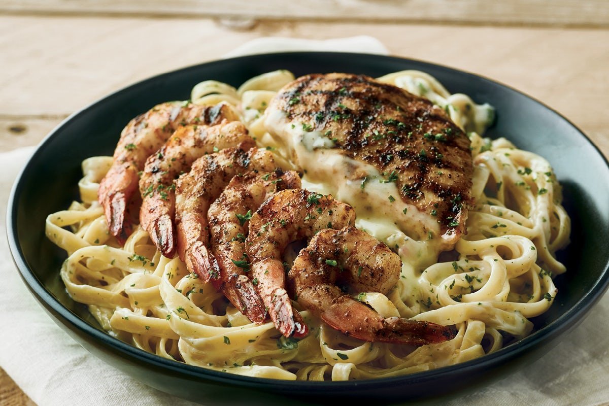 Fresh QUEENSLAND CHICKEN & SHRIMP PASTA prepared with coastal flavors and served with our signature sauces