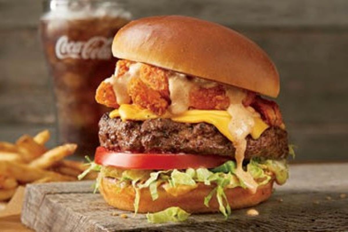 Hearty THE BLOOMIN' BURGER served on a toasted bun with fresh toppings and signature sauce